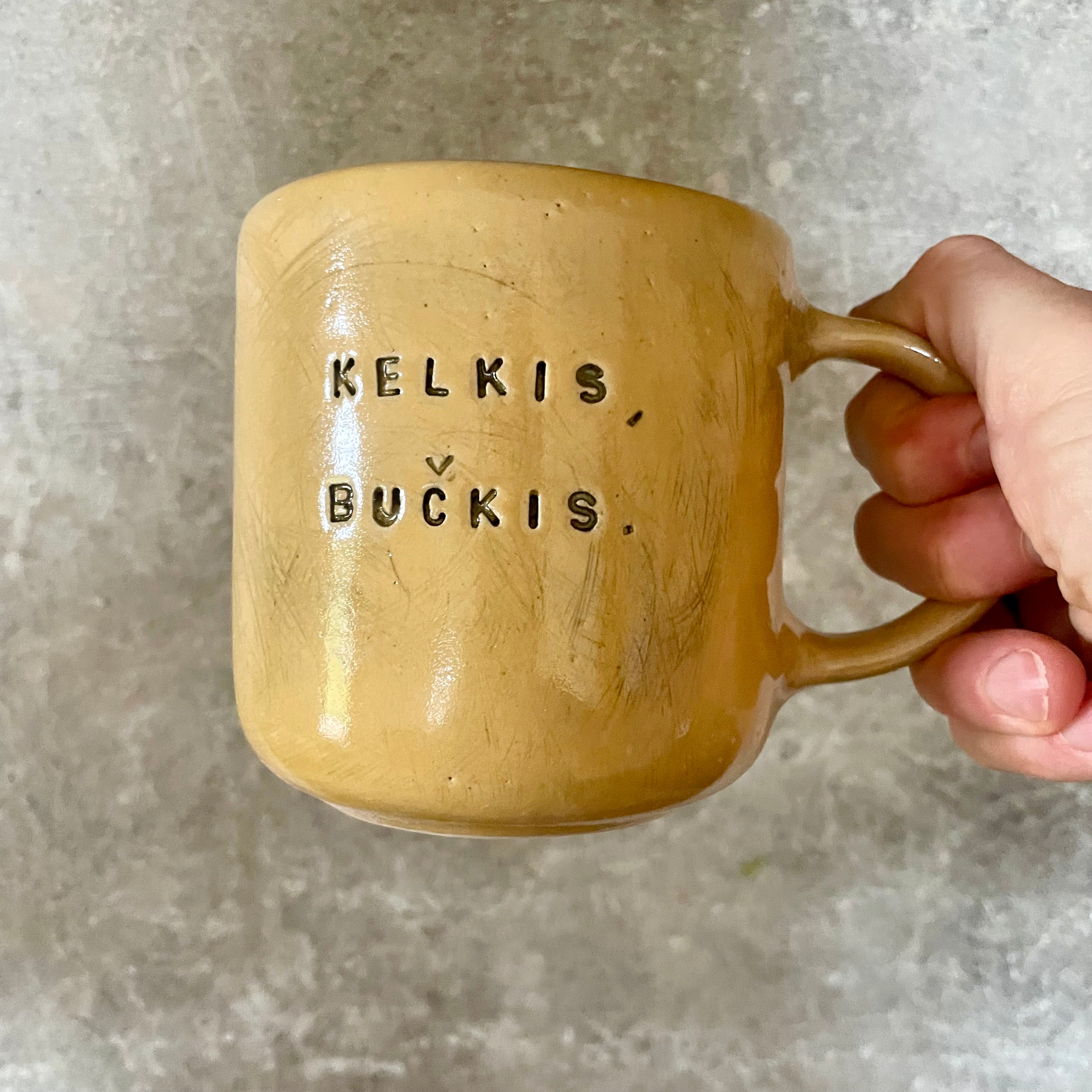 Big yellow mug with saying in Lithuanian