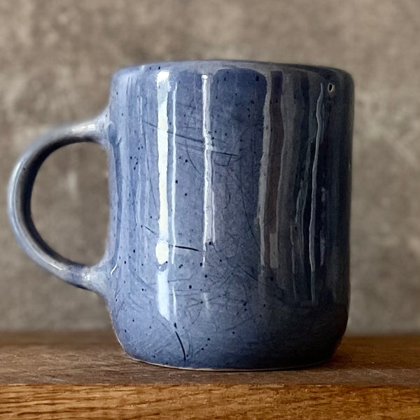 Blue mug with words in Lithuanian