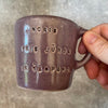 Small purple mug with words in Lithuanian