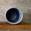 Blue ceramic mug without handle with words about work