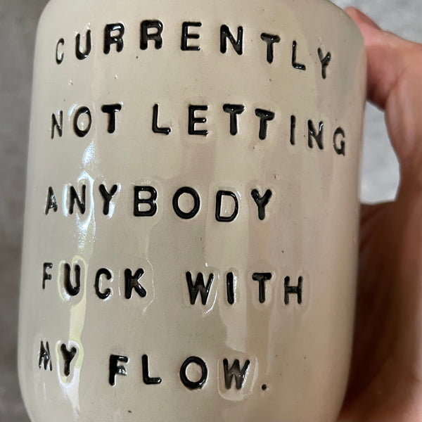 Ceramic coffee mug with saying about the flow