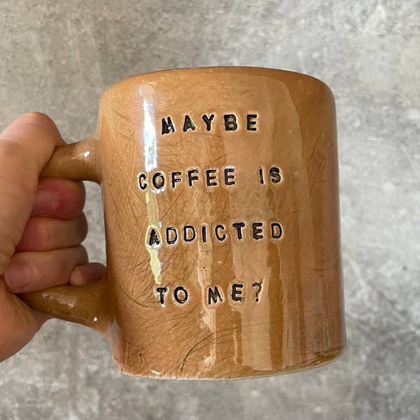 Brown mug with saying about coffee