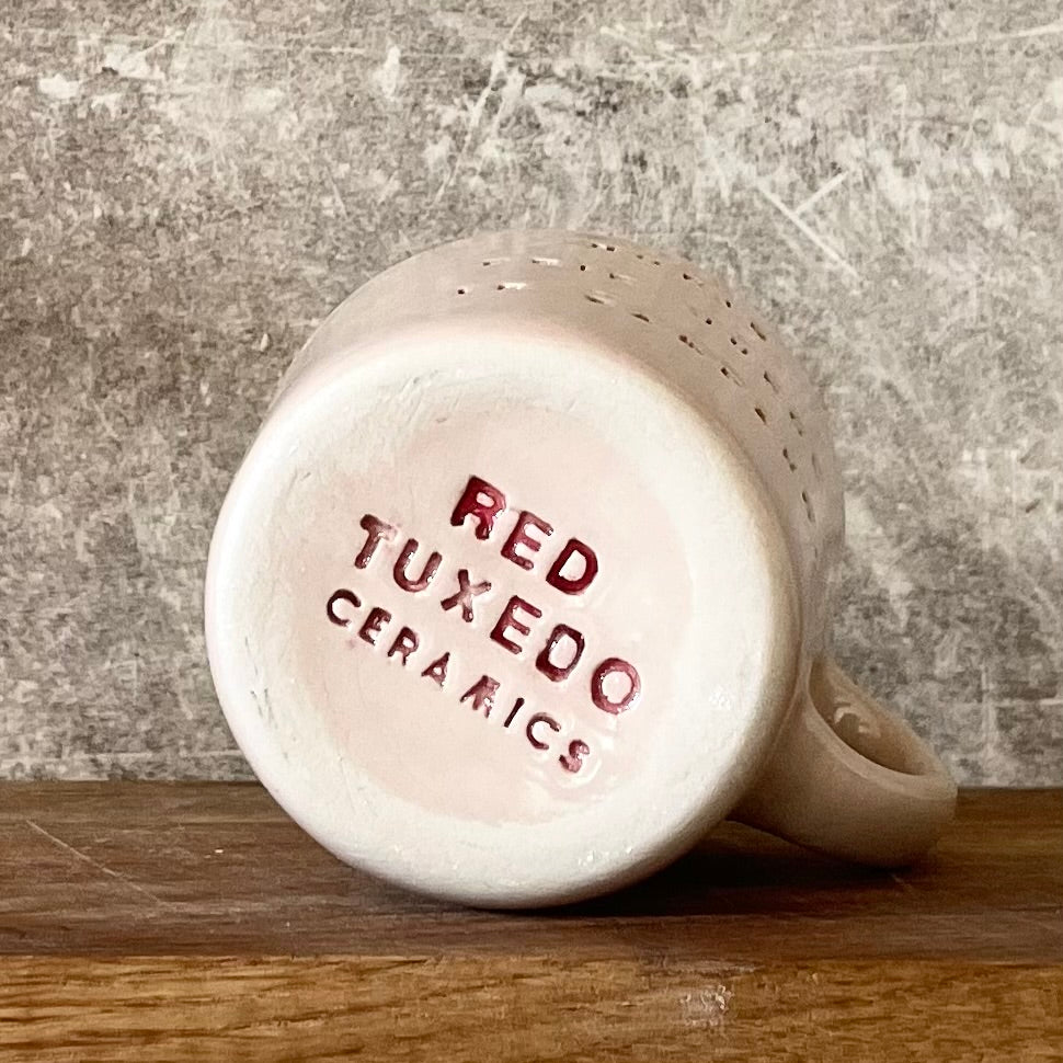 Small pink mug with words in Lithuanian
