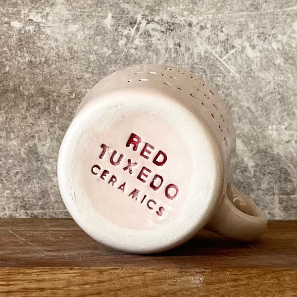 Small pink mug with words in Lithuanian