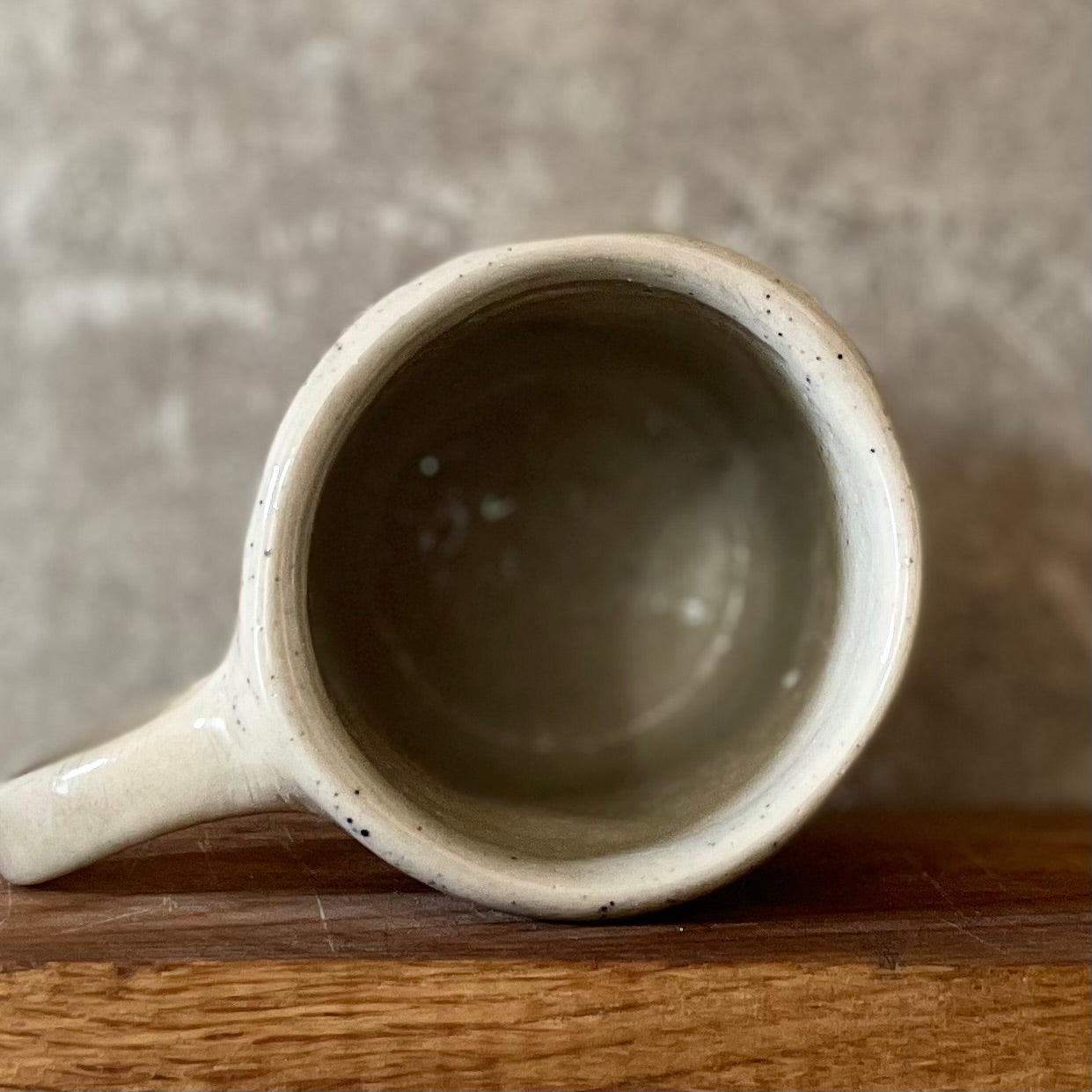 Speckled mug with words about work
