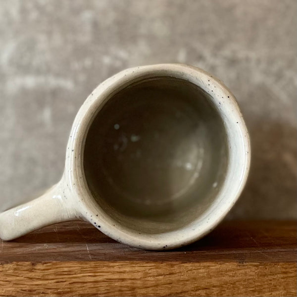 Speckled mug with words about work