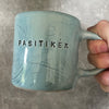 Blue ceramic mug with word PASITIKĖK