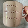Small pink mug with words in Lithuanian