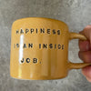 Yellow coffee mug with saying about happiness