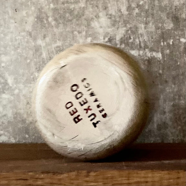 Beige tumbler mug with word RAMYBE