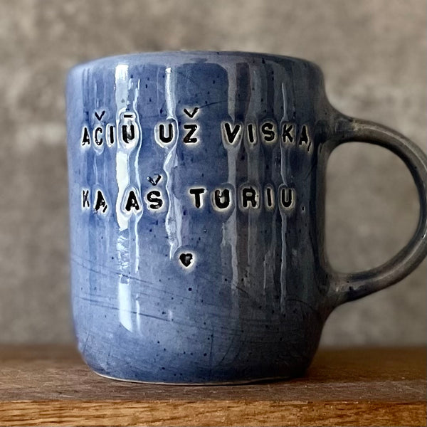 Blue mug with words in Lithuanian