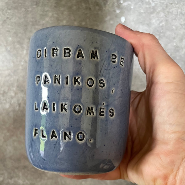 Blue ceramic mug without handle with words about work