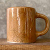 Brown mug with saying about coffee