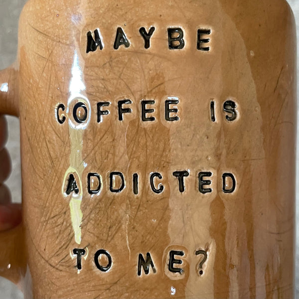 Brown mug with saying about coffee