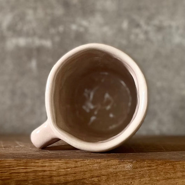 Small pink mug with words in Lithuanian