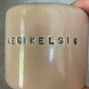 A pair of small mugs with words in Lithuanian