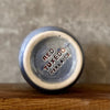 Blue ceramic mug without handle with words about work