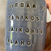 Blue ceramic mug without handle with words about work