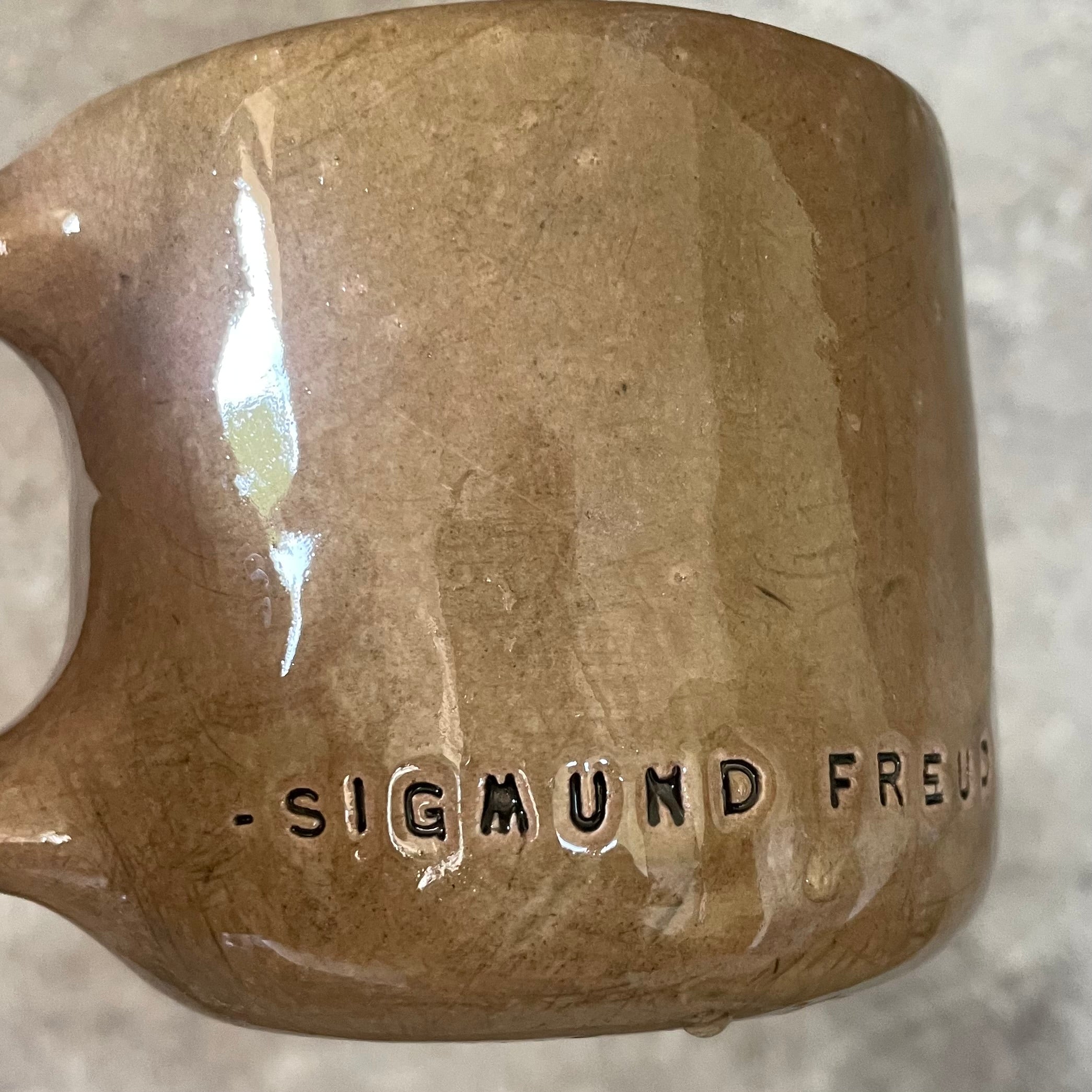 Brown mug with quote by S. Freud