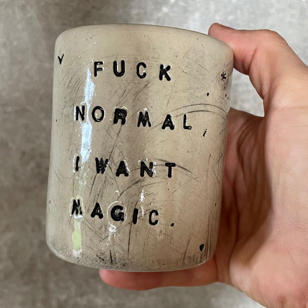 White mug with magic saying