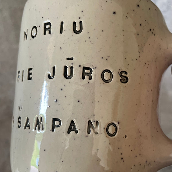 Speckled mug with saying in Lithuanian