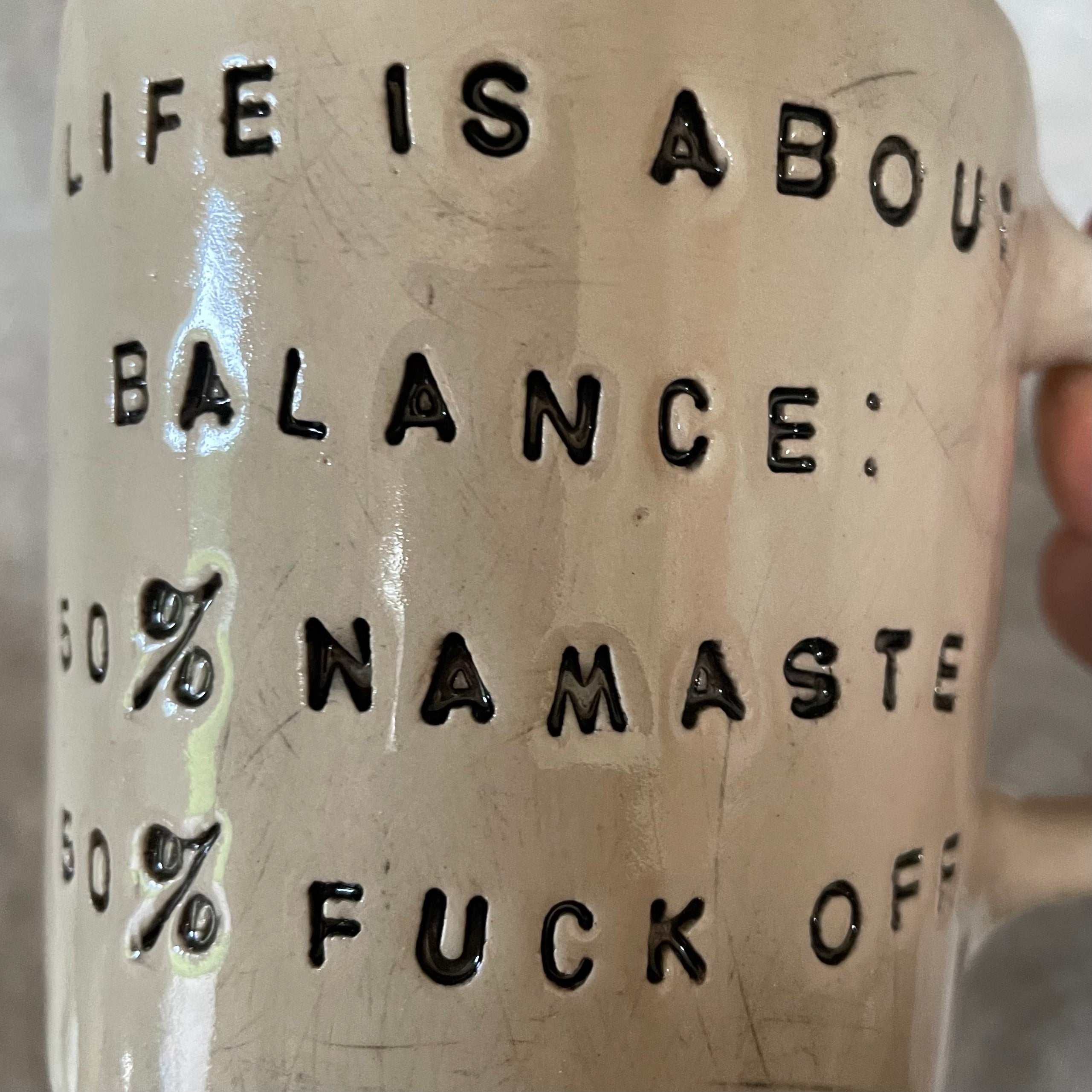 Ceramic mug with saying about balance with handle