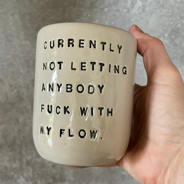 Ceramic coffee mug with saying about the flow