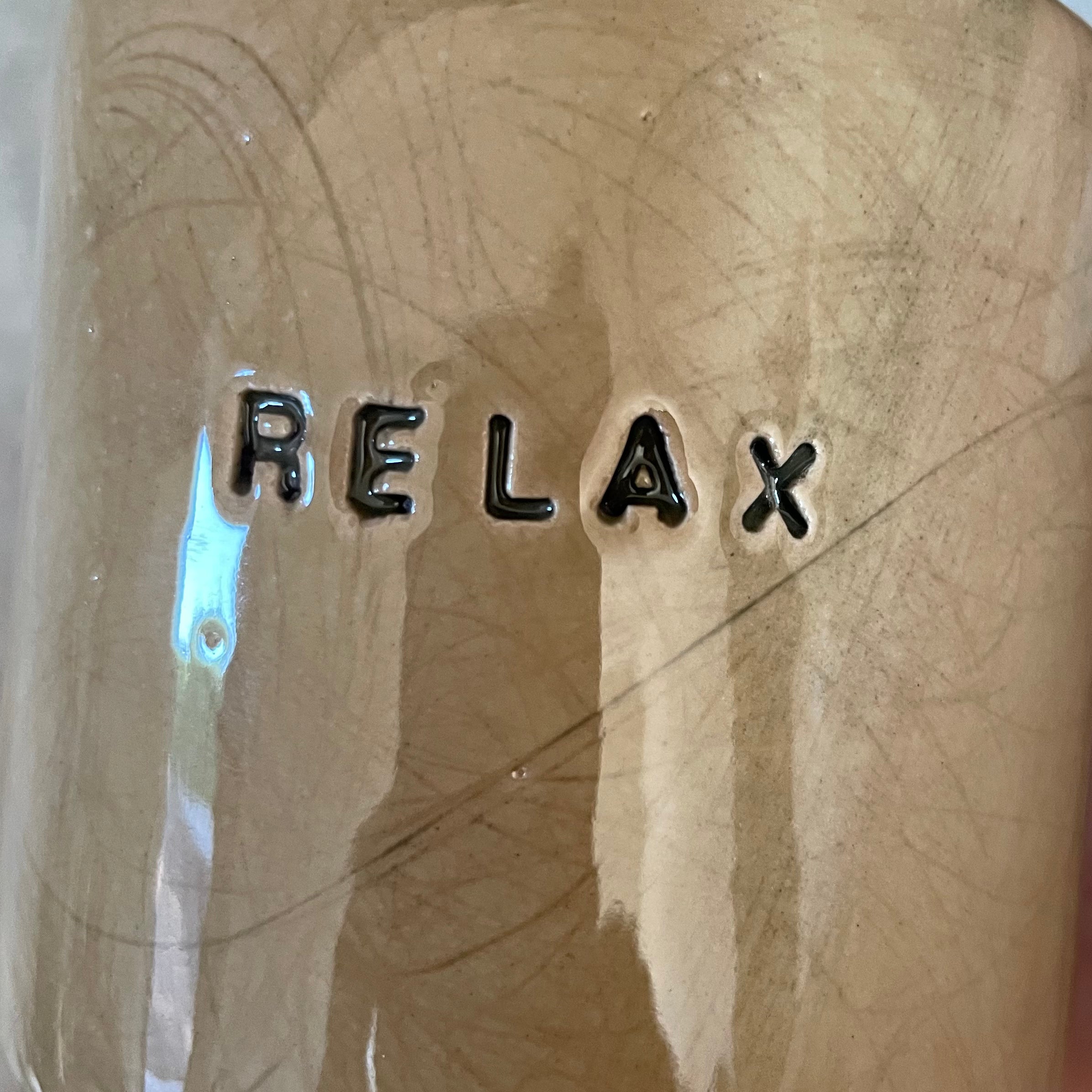 A pair of coffee mugs RELAX