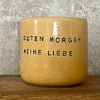 Yellow tumbler mug with words in German