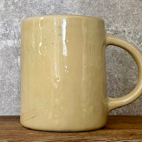 Yellowish coffee mug with funny saying