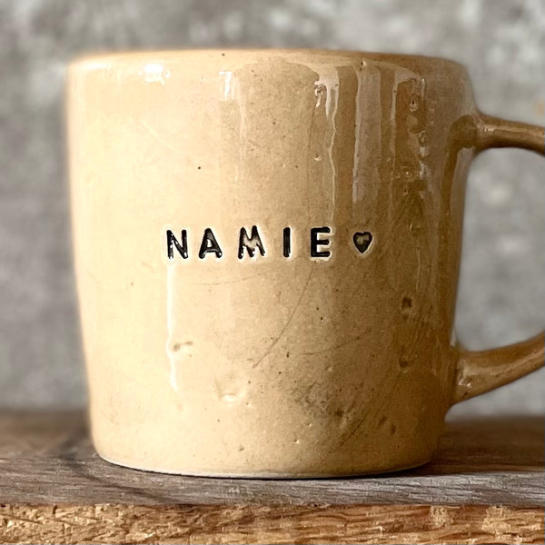 Caramel mug with word in Lithuanian NAMIE
