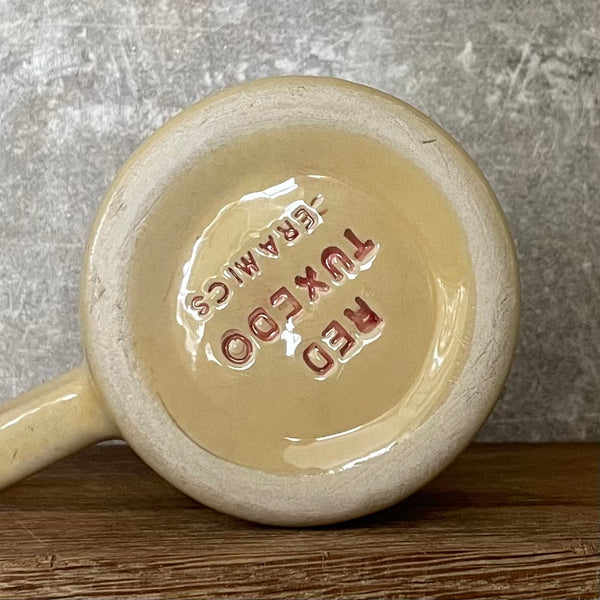 Yellowish coffee mug with funny saying