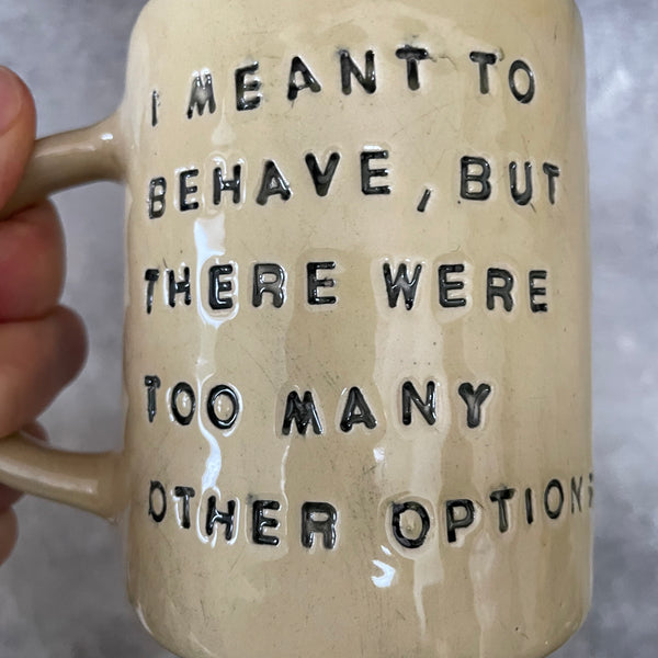 Yellowish coffee mug with funny saying