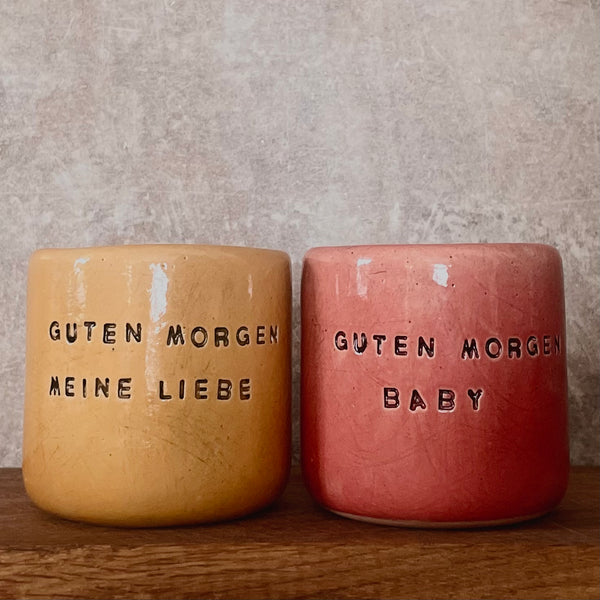 Yellow tumbler mug with words in German