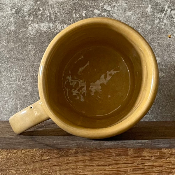 Yellow cup with saying "LABAS RYTAS"