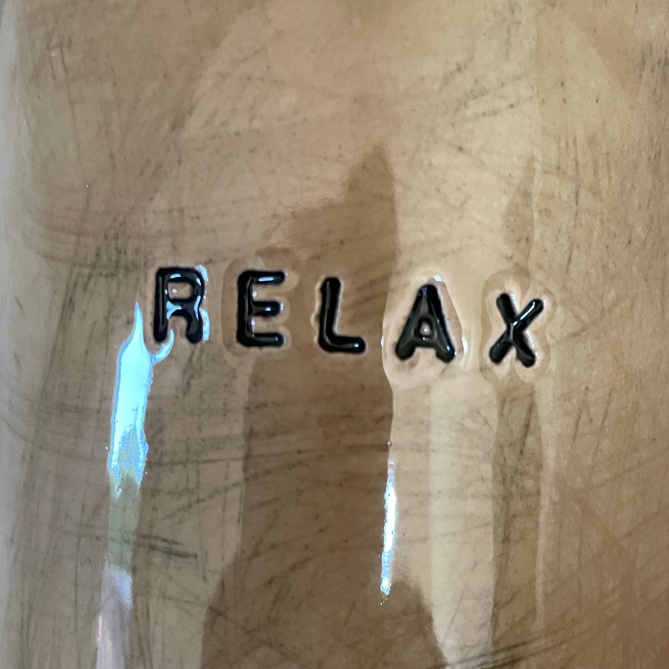 A pair of coffee mugs RELAX