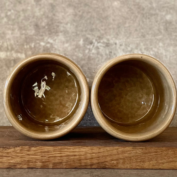 A pair of coffee mugs RELAX