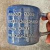 Blue ceramic coffee mug with quote