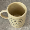 Yellowish coffee mug with funny saying