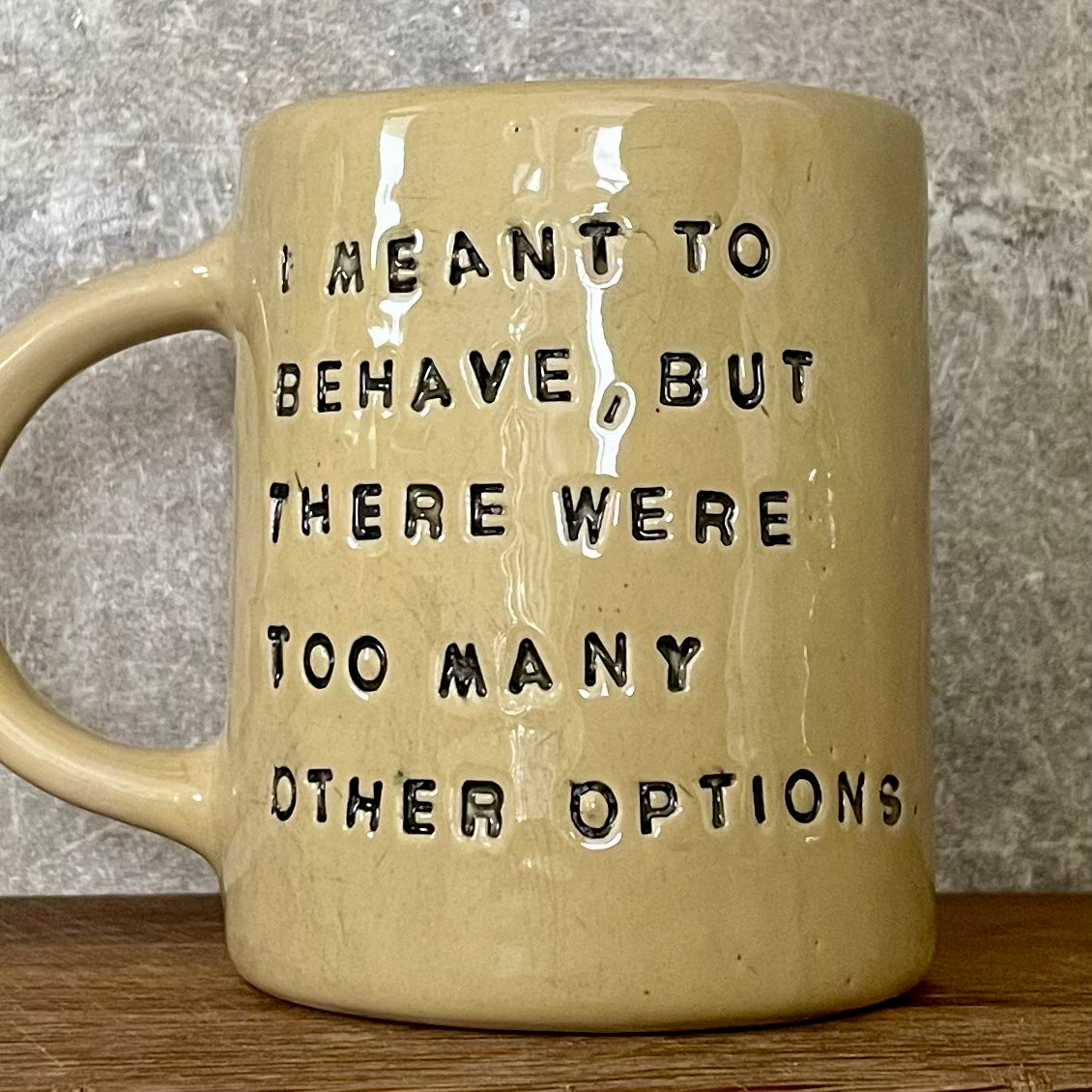 Yellowish coffee mug with funny saying