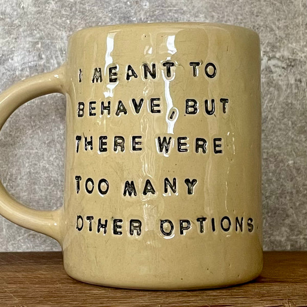 Yellowish coffee mug with funny saying