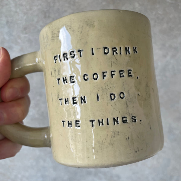 Yellow ceramic mug with saying about coffee