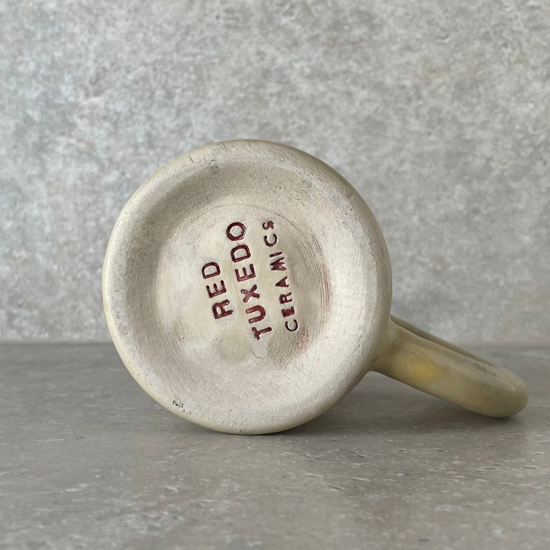 Yellow ceramic mug with saying about coffee