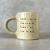 Yellow ceramic mug with saying about coffee
