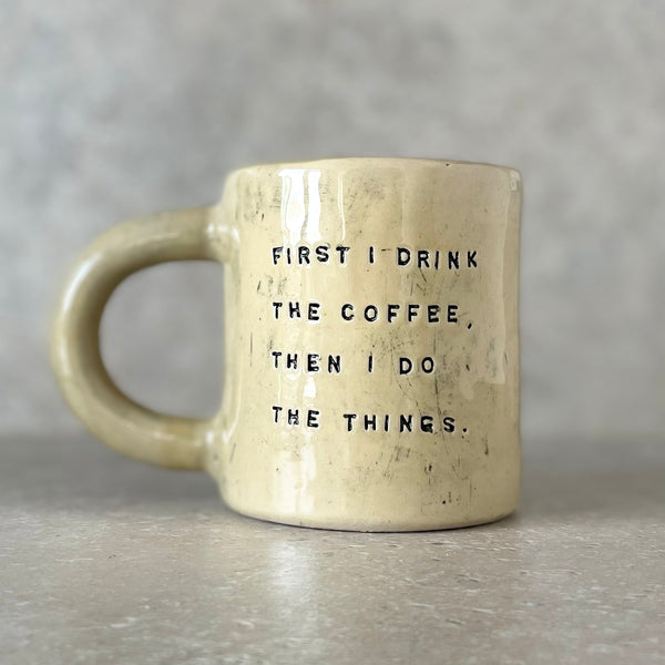 Yellow ceramic mug with saying about coffee