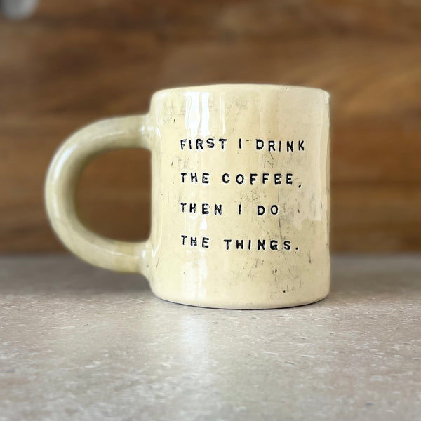 Yellow ceramic mug with saying about coffee