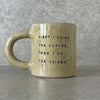 Yellow ceramic mug with saying about coffee