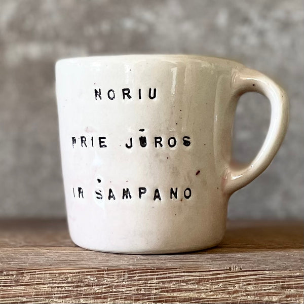 Small pink mug with words in Lithuanian