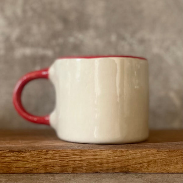 Puodelis su raudona rankena SKANIOS KAVELĖS