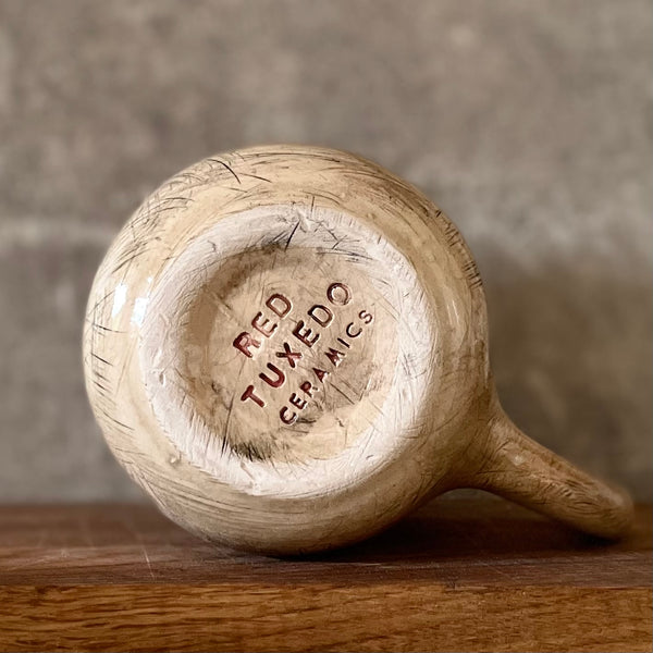 Big beige mug with saying in Lithuanian